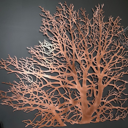 Silhouette of a bare tree from copper